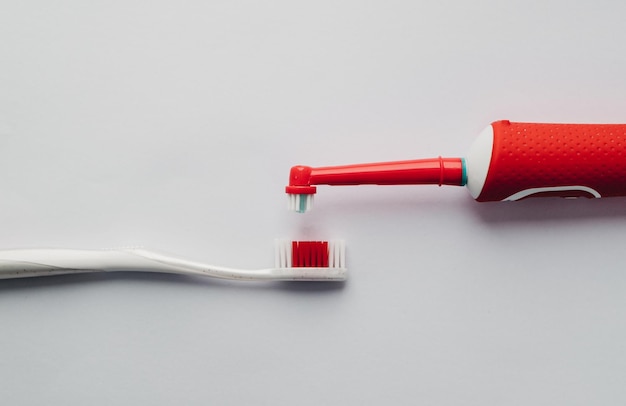 Red electric toothbrush on a white background