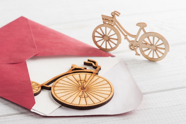 Red envelope with empty paper and wooden bikes