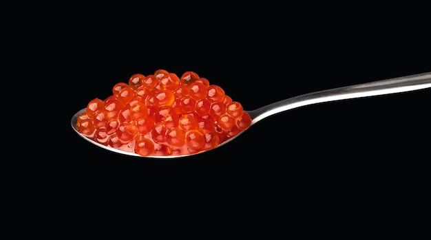 Red exclusive caviar macro photo isolated on dark background