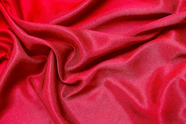 Red fabric cloth texture for background  of silk or linen.