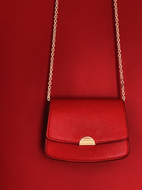 Red fashionable leather purse with gold details as designer bag and stylish accessory female fashion and luxury style handbag collection concept