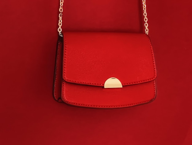 Red fashionable leather purse with gold details as designer bag and stylish accessory female fashion and luxury style handbag collection concept