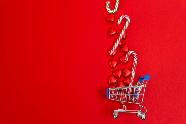 Red festive Christmas background with a supermarket cart