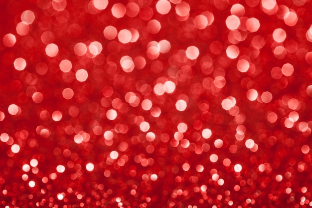 Red festive glitter background with defocused lights