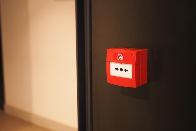 Red fire alarm button on wall