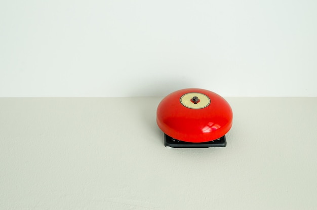 Red fire alarm on wall background