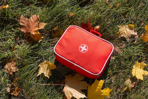 Red first aid kit on the grass