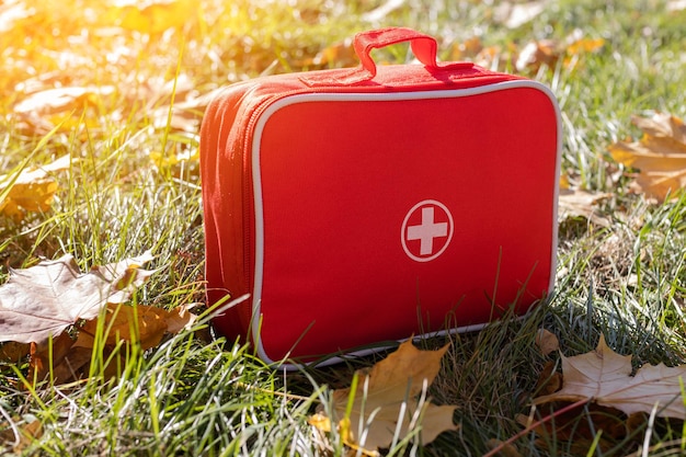 Red first aid kit on the grass