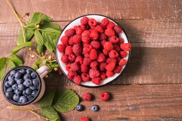 Red fresh ripe raspberry in a bowl