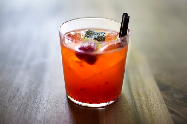 Red fruit detox drink on wooden background