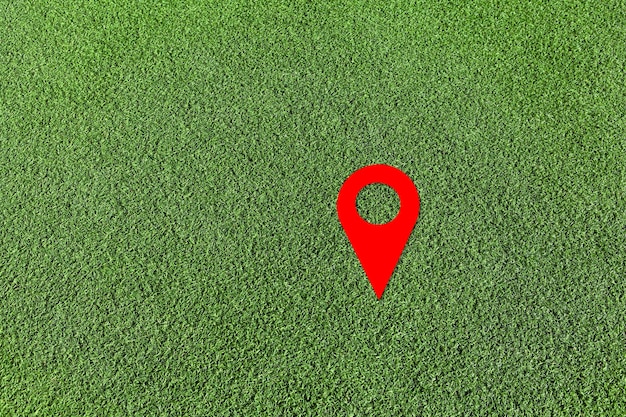 Red geo locate symbol on green lawn Design element Artificial green grass Empty space