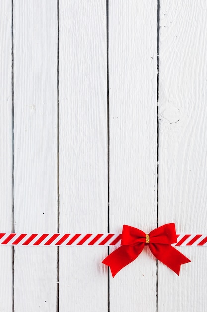 Red gift bow with ribbon on table 