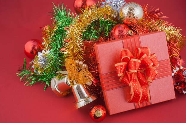 Red Gift Box with Decorations on Red background. Christmas Holiday Concept