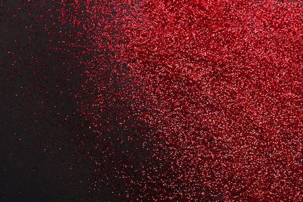 Red glitter sand isolated on black