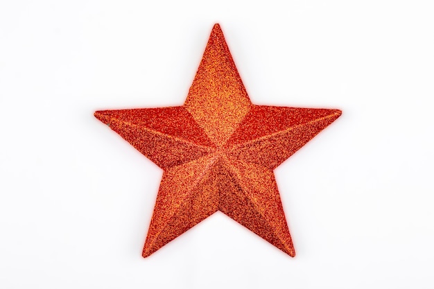 Red glitter star isolated on a white background typical of the christmas tree