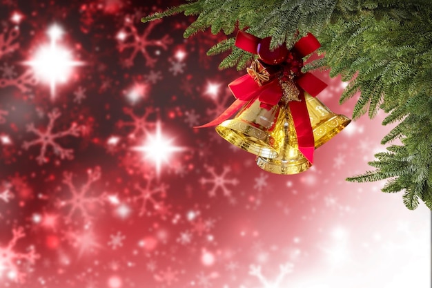 A red and gold christmas tree decoration with a red bow and a red background.