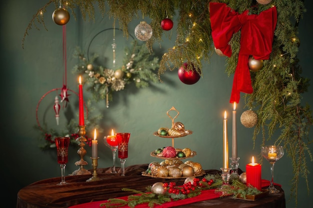 red and golden christmas decor on table on dark background