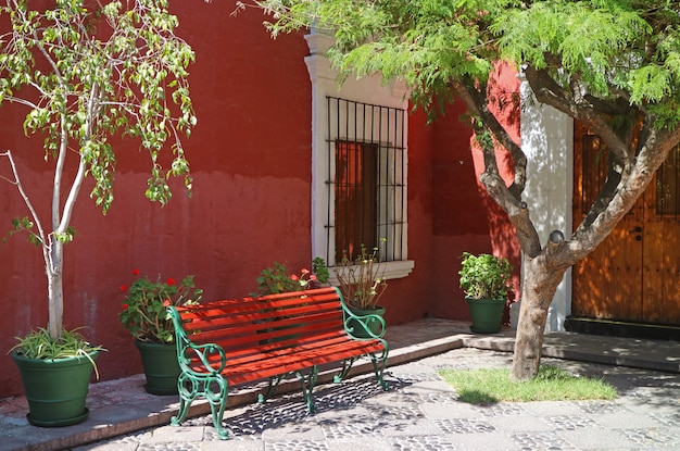 Red and green bench in the sunshine garden of Arequipa, Peru, South America