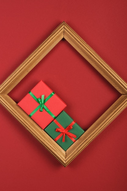 red and green gift box in gold frame on red background