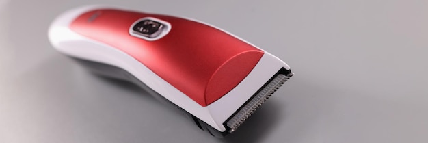 Photo red hair clipper on a gray background