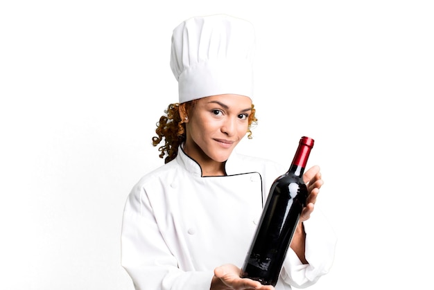 Red hair pretty chef woman holding a wine bottle