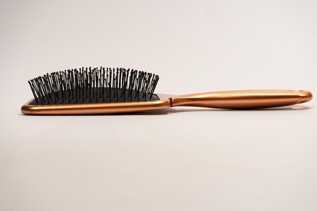 A red hairbrush isolated on a white background Hair tools