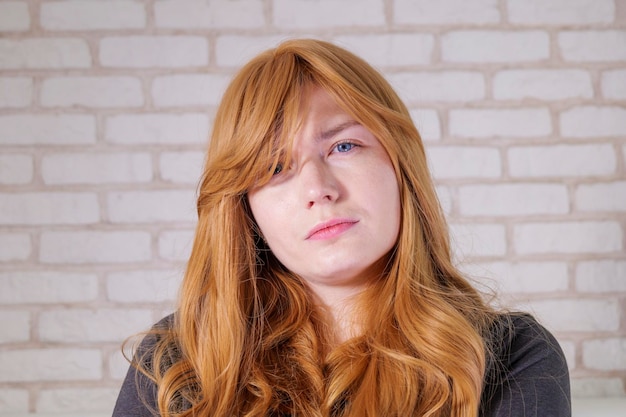 Red-haired girl portrait. girl looking at the camera.