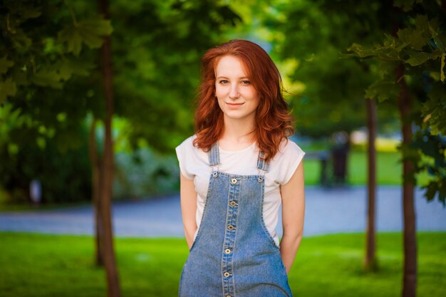 Red-haired girl posing in the park