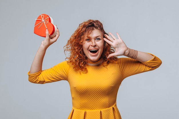 Red-haired girl received a gift box heart