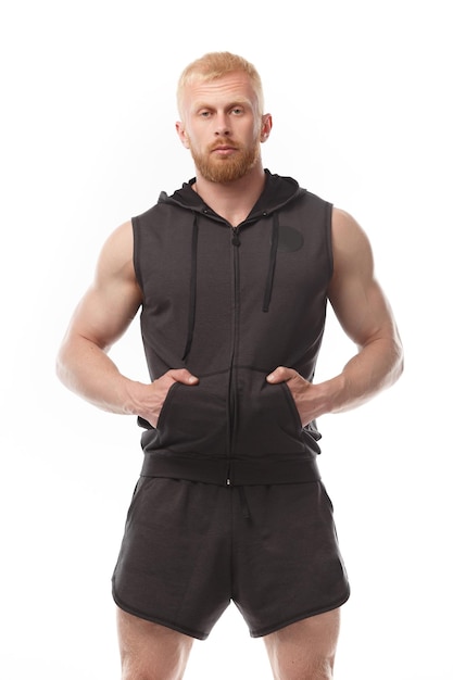 Red-haired man of athletic physique on white isolated background