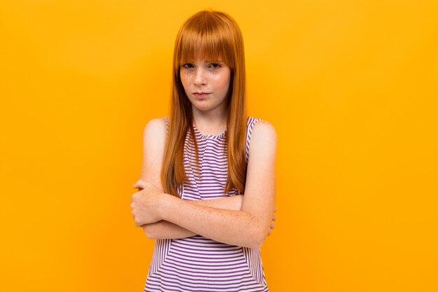 Red-haired smiling beautiful girl in a T-shirt grimaces