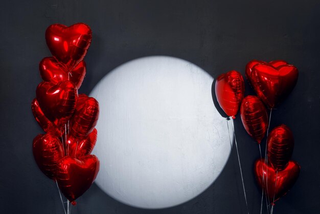 Red heart balloons on dark background