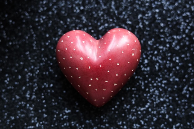 Red heart on black glitter background valentines day concept