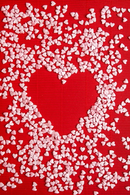 red heart in the centre as a background shaped with lots of small light pink hearts around