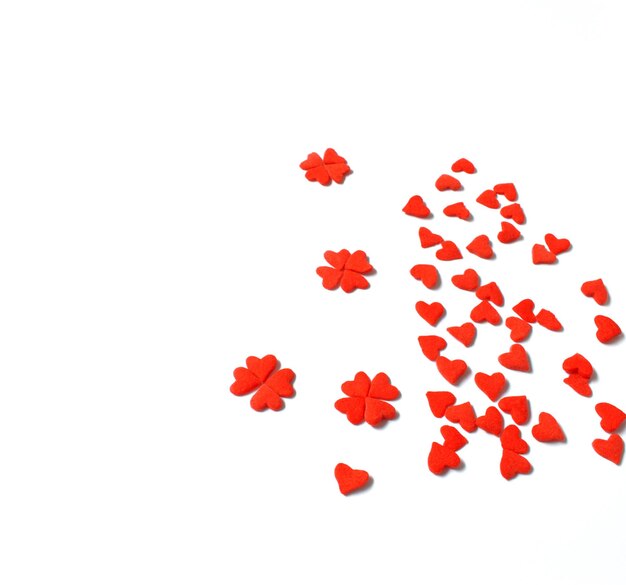 Photo red heart shape decorations over white background