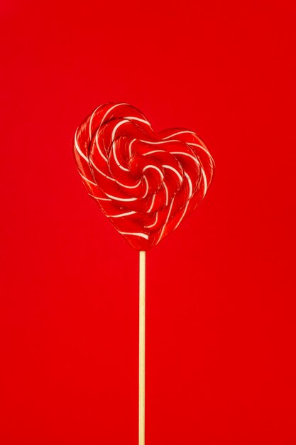 Red heart shape lollipop on red room