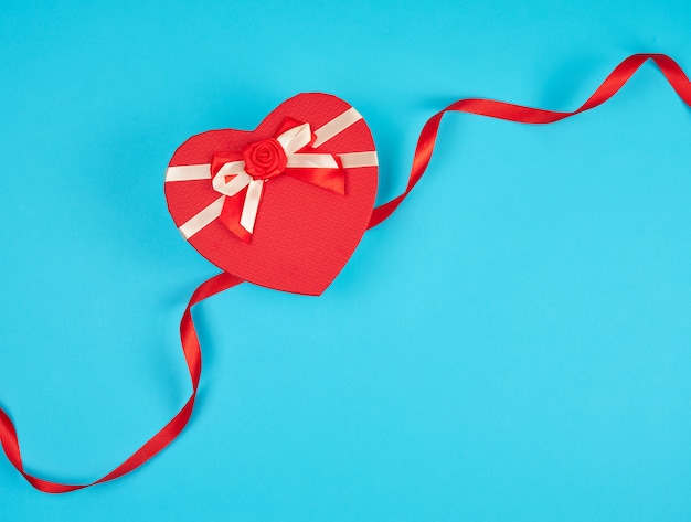 Red heart-shaped gift box with a bow 