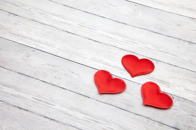 Red heart on white wooden Background.