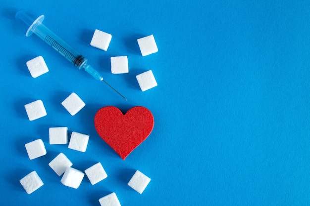 Red heart with sugar cubes and syringe