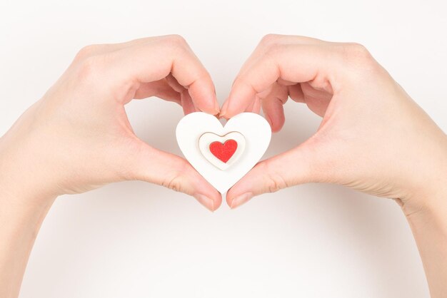 Red heart in woman hand isolated. Copy space.