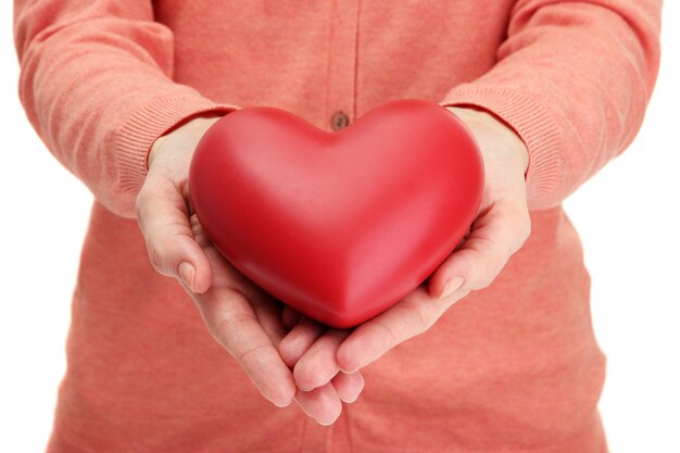 Red heart in woman hands, close up