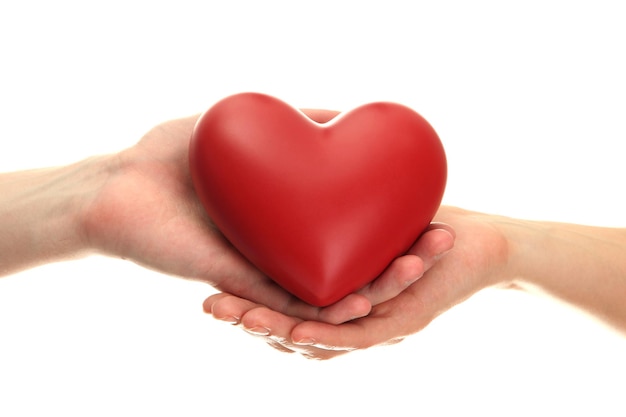 Red heart in woman and man hands, isolated on white