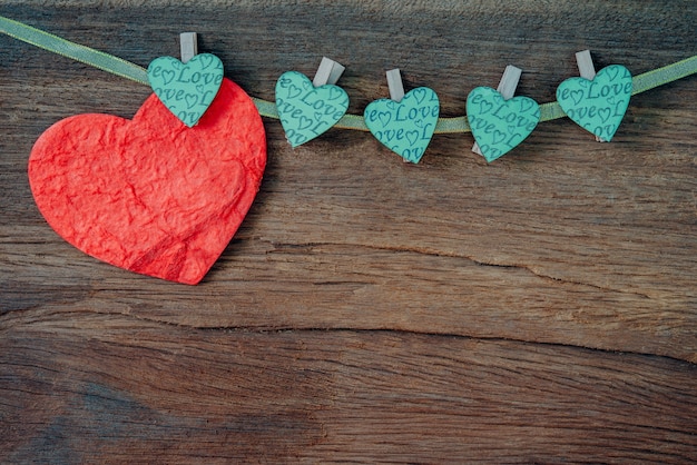 Red heart on wooden background.