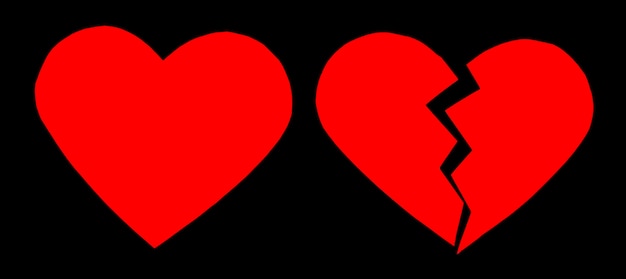 Red heartbreak / broken heart. close up of a paper broken heart on black background with clipping path