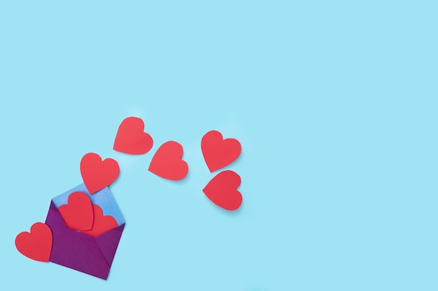 Red hearts go out From the envelope on the blue background