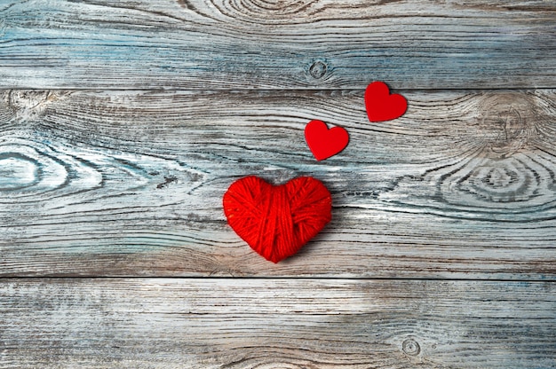 Red hearts on a wooden gray-blue background.