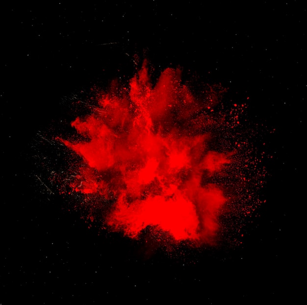 Red holi paint powder explosion isolated on black background