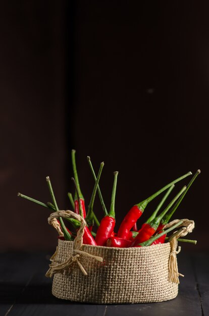 Red hot Chili pepper in baskets on wooden table