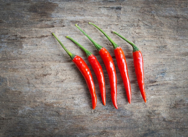 Red hot chili peppers on old wood table background