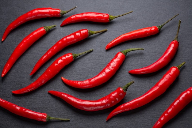 Red hot pepper on a dark background. Shale plate..